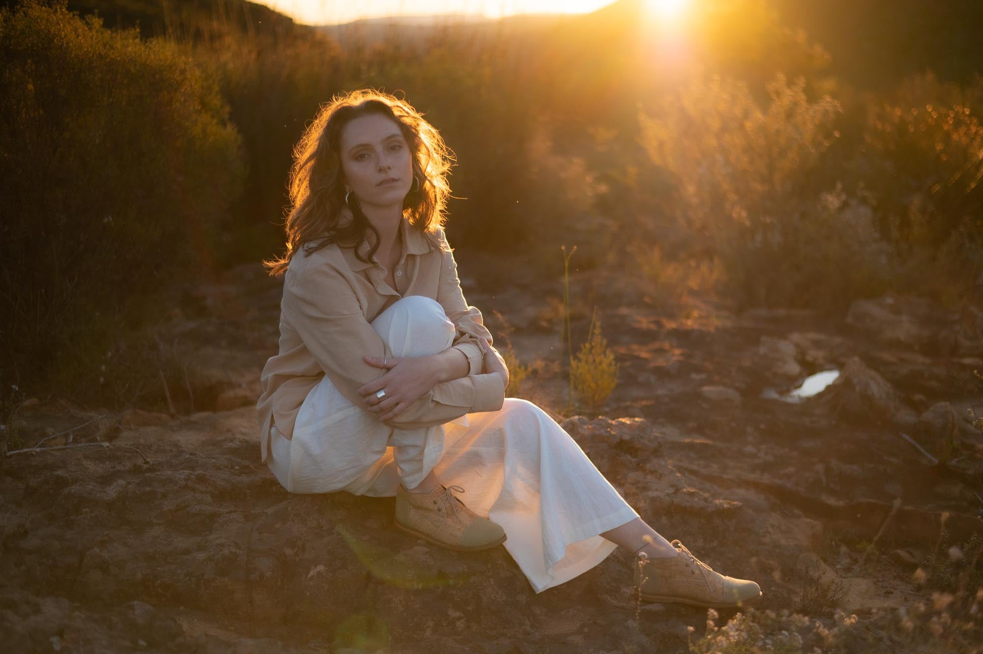 women sitting in field wearing hemp linen clothes made by Sage & Sunday a cape town clothing brand