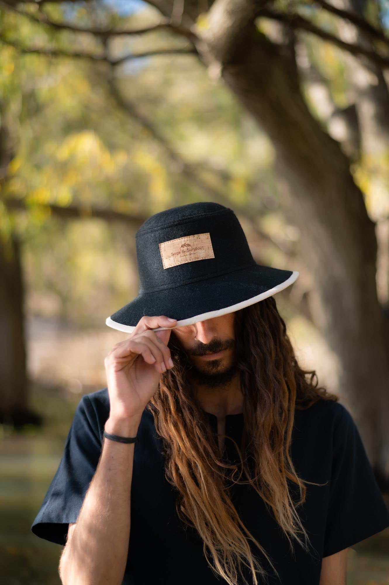 man wearing a recycled plastic bucket hat made by Sage & Sunday a cape town clothing brand